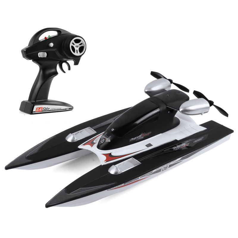 Black and white remote control boat with a throttle handle on a white background